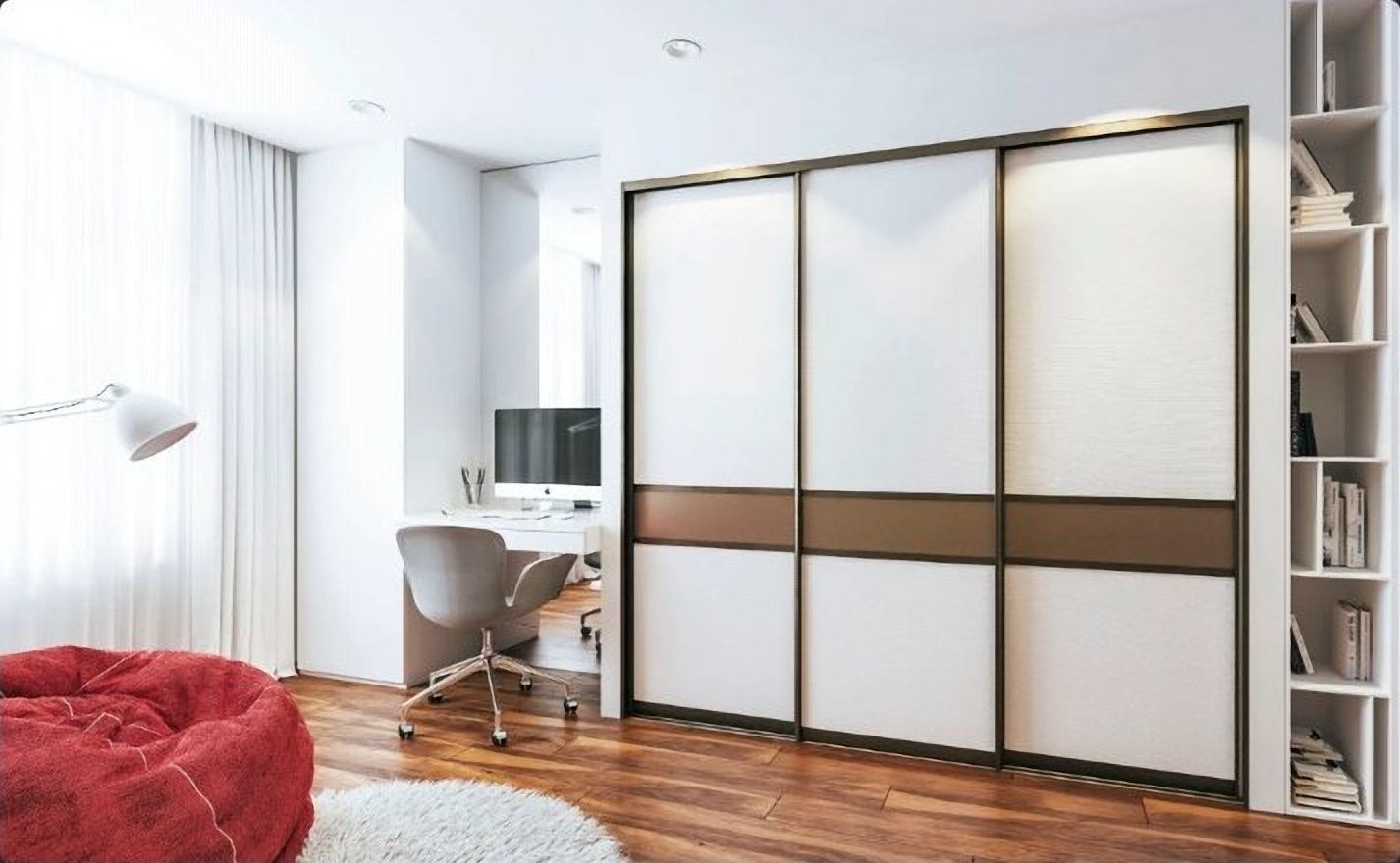 White aluminum sliding closet doors with a bronze panel band in a bright bedroom