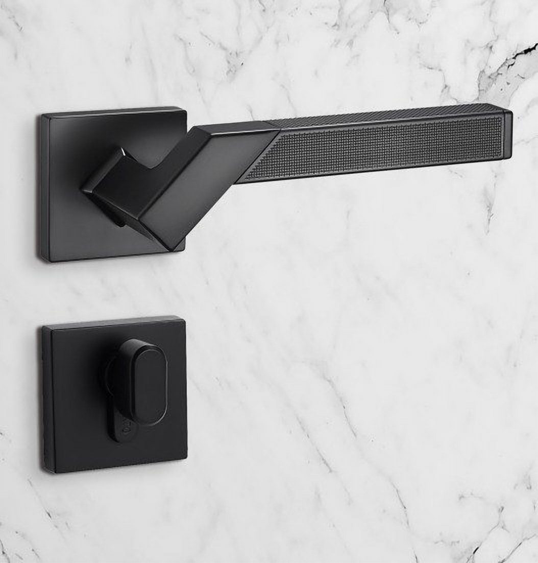 Orlando lever handle in black on a marble wall